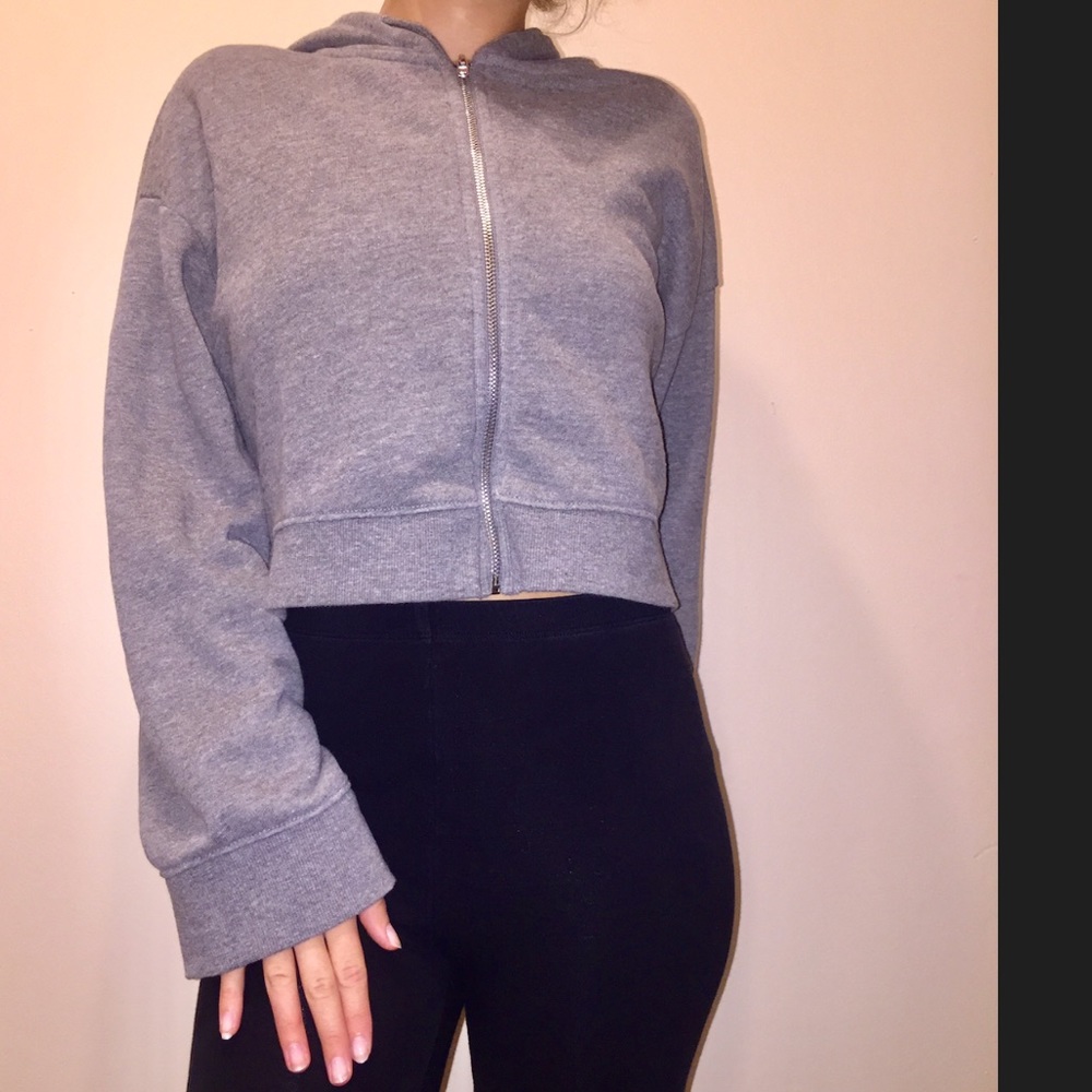 A long sleeve, grey, crop top hoodie